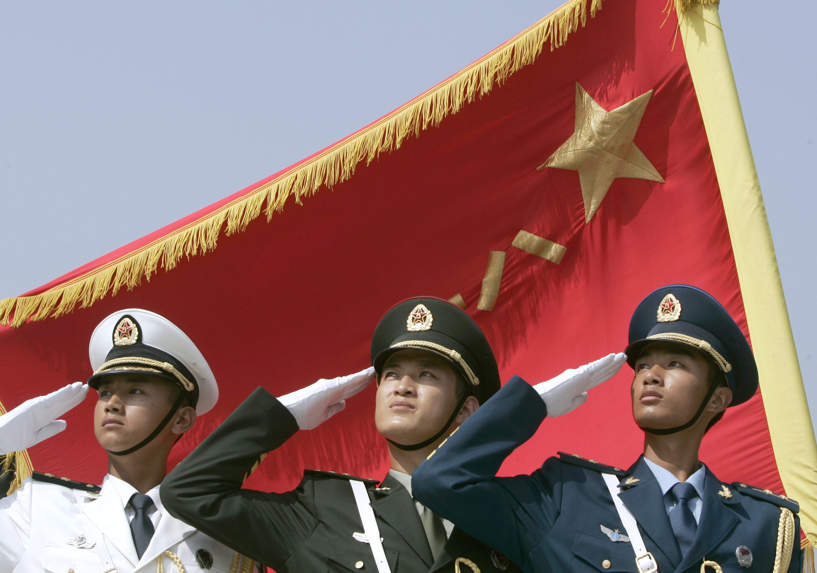 Honour guards from the navy, land, and air force dress in the latest uniform and salute in formation in Beijing