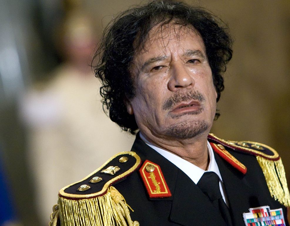 Libya's leader Gaddafi looks on during a news conference in Rome