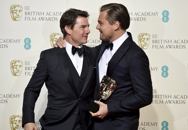 Leonardo DiCaprio holds his award for best leading actor as he embraces presenter Tom Cruise at the British Academy of Film and Television Arts (BAFTA) Awards at the Royal Opera House in London