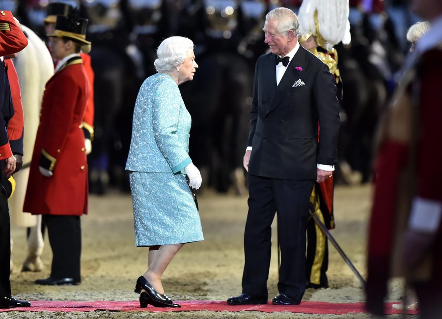 epa05308755 Britain's Queen Elizabeth II (C) is welcomed by her son Britain's Prince of Wales, Prince Charles (R) as she arrives at the Queen's 90th Birthday celebrations at the Royal Windsor Horse Show in the grounds of Windsor Castle in Windsor near London, Britain, 15 May 2016.  EPA/HANNAH MCKAY