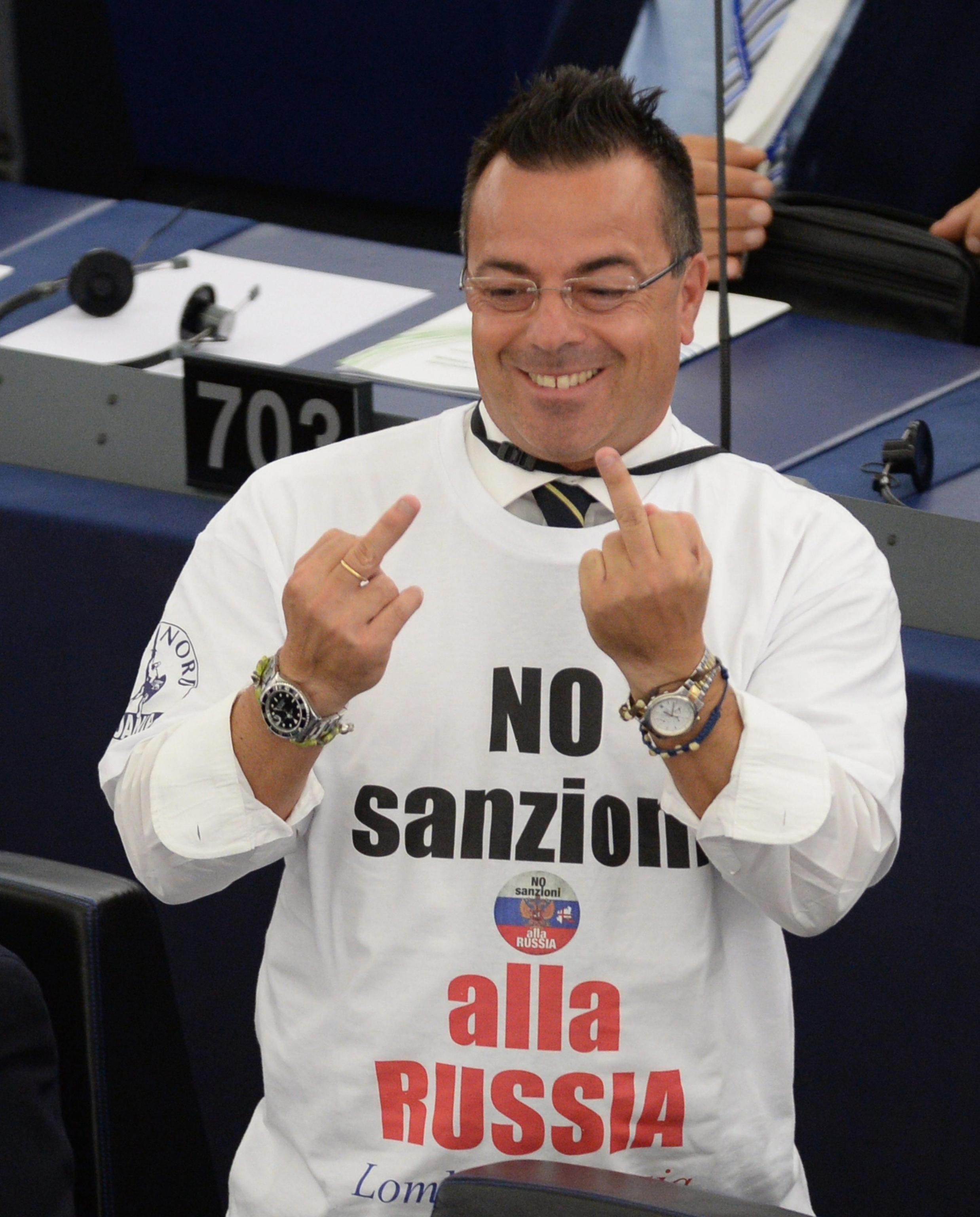 epa04402541 Italian member of the European Parliament (MEP) Gianluca Buonanno, of the Italian Lega Nord, wears a protest t-shirt with the slogan 'No Sanzioni alla Russia' (No Sanctions on Russia) during the plenary session at the European Parliament in Strasbourg, France, 16 September 2014. The parliaments of Ukraine and the European Union were set 16 September to ratify a landmark political and free trade deal, but some lawmakers expressed displeasure over a delay in the agreement. The political and trade deal ratified by parliaments in Ukraine and the European Union were the first step towards membership in the bloc, Ukrainian President Petro Poroshenko said. EPA/PATRICK SEEGER