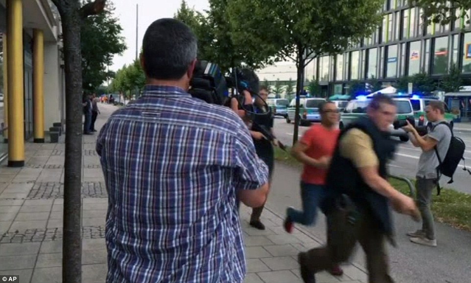368285F300000578-3703705-Armed_police_move_past_onlooking_media_responding_to_a_shooting_-a-49_1469209425518