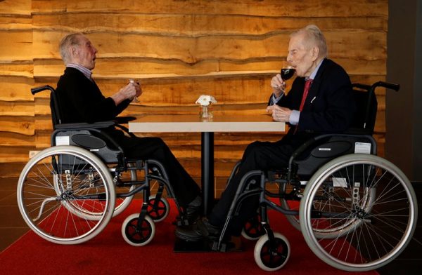 The world's oldest living twin brothers, Paulus (L) and Pieter Langerock from Belgium, 102, drink a glass of red wine at the Ter Venne retirement home in Sint-Martens-Latem, Belgium, July 4, 2016. The twins will celebrate their 103rd birthday on July 8, 2016. Picture taken July 4, 2016.  REUTERS/Francois Lenoir