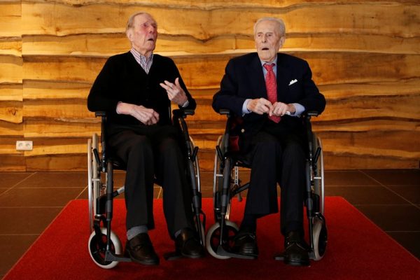 The world's oldest living twin brothers, Paulus (L) and Pieter Langerock from Belgium, 102, pose at the Ter Venne retirement home in Sint-Martens-Latem, Belgium, July 4, 2016. The twins will celebrate their 103rd birthday on July 8, 2016. Picture taken July 4, 2016.  REUTERS/Francois Lenoir