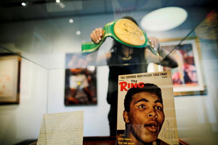 A woman arranges the Iconic 'Rumble in the Jungle' belt of late boxing champion Muhammad Ali at Heritage Auctions house in Manhattan, New York, U.S., August 19, 2016. REUTERS/Eduardo Munoz