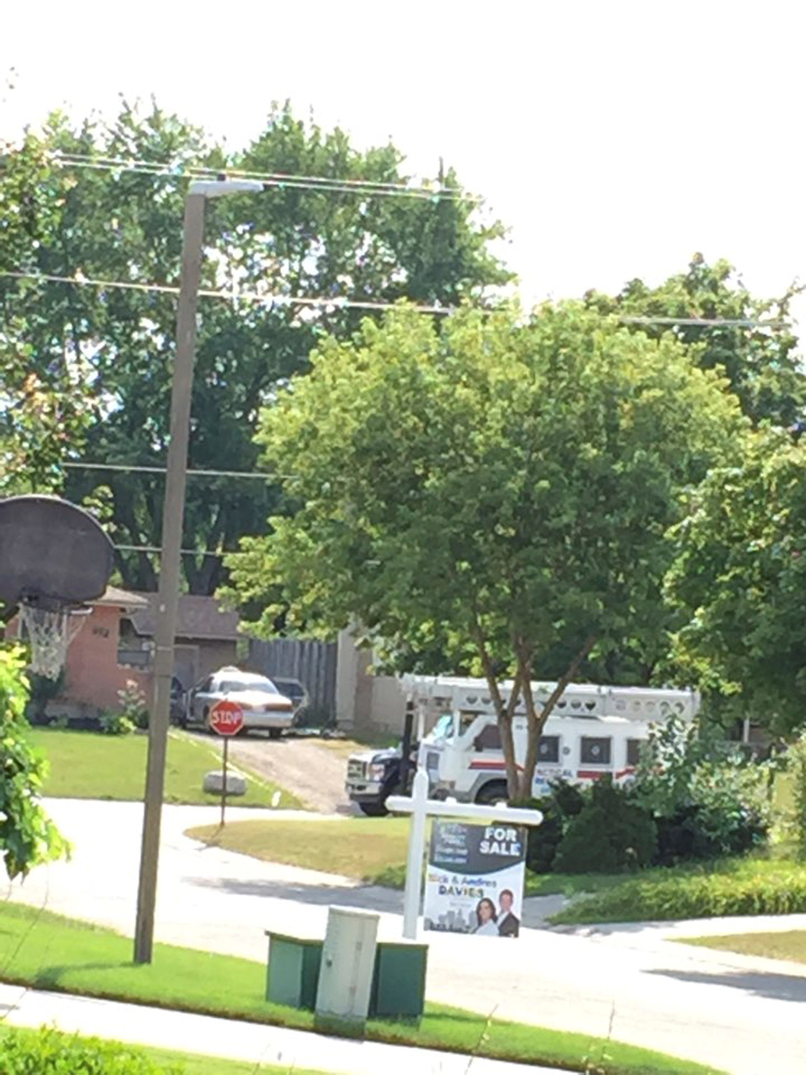 Police vehicle is pulled up to for a raid at a home after they received "credible information of a potential terrorist threat" at a small community some 225 km (140 miles) southwest of Toronto in Strathroy, Ontario, Canada August 10, 2016.  REUTERS/Stringer   ATTENTION EDITORS - THIS IMAGE WAS PROVIDED BY A THIRD PARTY. EDITORIAL USE ONLY. NO RESALES. NO ARCHIVE.