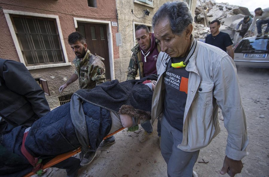 epa05508217 An injured person is taken on a stretcher in Amatrice, central Italy, 24 August 2016, following a 6.2 magnitude earthquake, according to the United States Geological Survey (USGS), that struck at around 3:30 am local time (1:30 am GMT). The quake was felt across a broad section of central Italy, including the capital Rome where people in homes in the historic center felt a long swaying followed by aftershocks. According to reports at least 21 people died in the quake, 11 in Lazio and 10 in Marche regions.  EPA/MASSIMO PERCOSSI