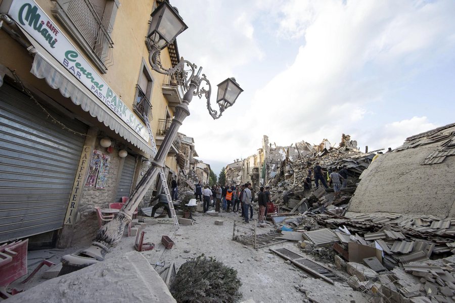 epa05508227 A view of collapsed and damaged houses in Amatrice, central Italy, 24 August 2016, following a 6.2 magnitude earthquake, according to the United States Geological Survey (USGS), that struck at around 3:30 am local time (1:30 am GMT). The quake was felt across a broad section of central Italy, including the capital Rome where people in homes in the historic center felt a long swaying followed by aftershocks. According to reports at least 21 people died in the quake, 11 in Lazio and 10 in Marche regions.  EPA/MASSIMO PERCOSSI