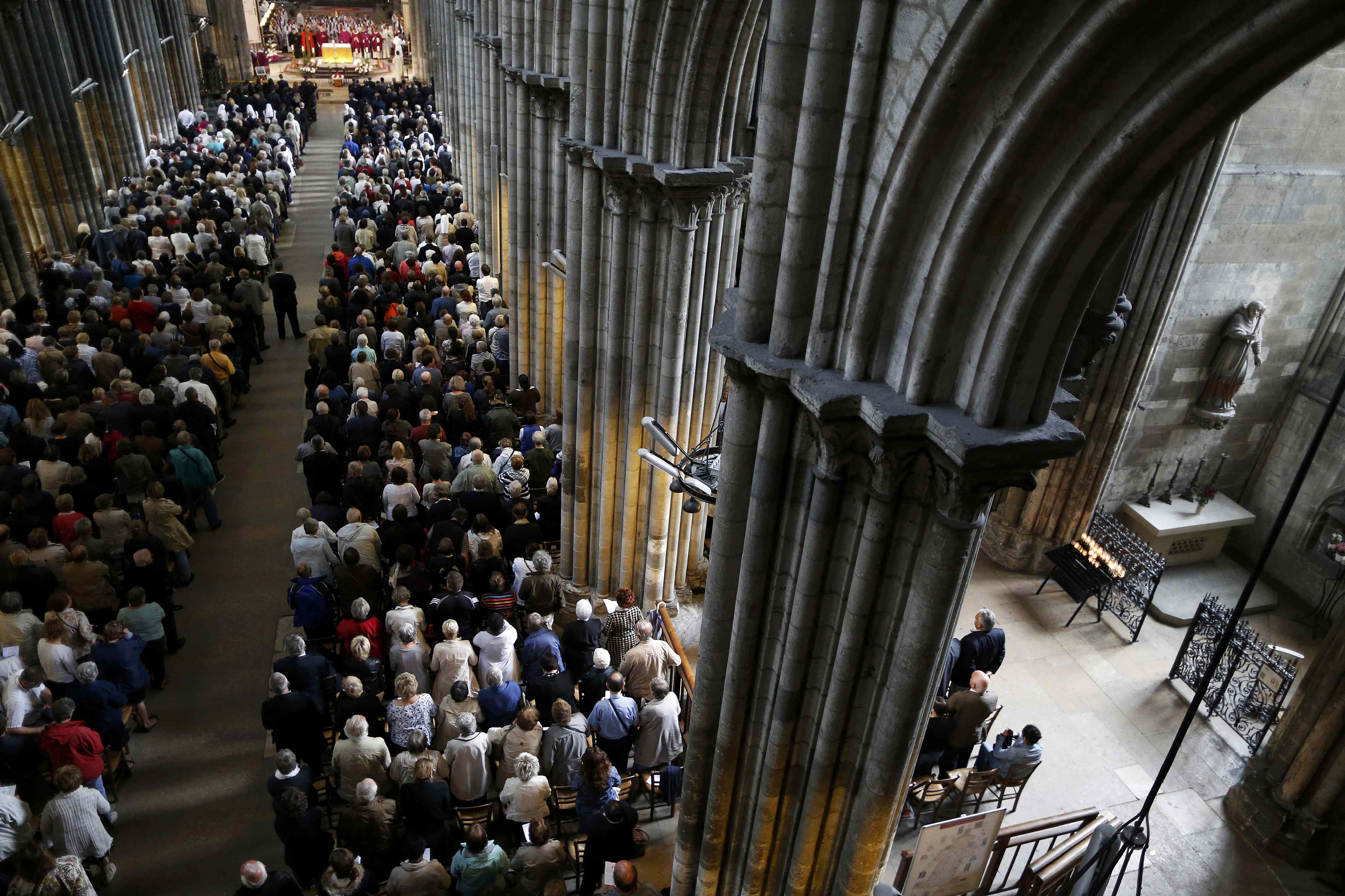 People attend a funeral service to slain French parish priest Father Jacques Hamel at the Cathedral in Rouen, France, August 2, 2016. Father Jacques Hamel was killed last week in an attack on a church at Saint-Etienne-du-Rouvray near Rouen that was carried out by assailants linked to Islamic State. REUTERS/Charly Triballeau/Pool