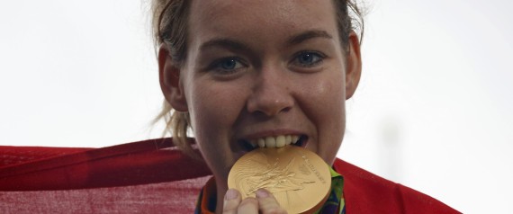 2016 Rio Olympics - Cycling Road - Final - Women's Road Race - Fort Copacabana - Rio de Janeiro, Brazil - 07/08/2016. Anna van der Breggen (NED) of Netherlands bites the gold medal on the podium.      REUTERS/Eric Gaillard  TPX IMAGES OF THE DAY FOR EDITORIAL USE ONLY. NOT FOR SALE FOR MARKETING OR ADVERTISING CAMPAIGNS.