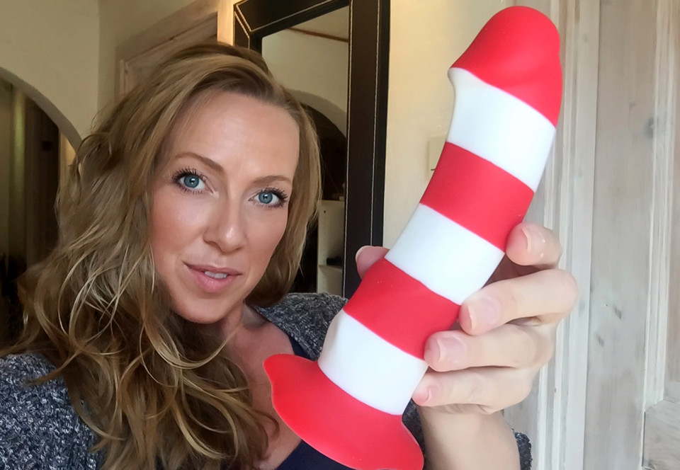 Pic shows: Joan B, 41 yo mother and dildo tester. This is the surprising story of a mother of three who has made a career out of blogging about sex toys for the last 16 years. Joan B. from Denmark says there are still a lot of taboos about dildos, even though they should be seen as a way to boost oneâs sex life rather than as a crutch. Called the "Dildo Queen" by a menâs magazine editor back in 2000, the 41-year-old started being a dildo tester and sexblogger on joanb.dk. She had always been interested in sex toys, recalling how many years ago she first found comfort in her electric toothbrush. She said: "I have never been frightened of dildos. In fact I was very young when I first had an orgasm in my own company. I still remember vividly one afternoon being at home alone. I was about to brush my teeth with my electric toothbrush. And for unknown reasons I put the end of the vibrating toothbrush between my legs." From that moment on, she was hooked, she said, with her greatest fear being running out of batteries. Joan says she is still surprised today that people are so averse to dildos, especially men, who see them as necessary evils if something down there is not working the way it should. However, she balances that statement with the notion that there is a "very horny group of people who were very far-sighted" and who see such devices as a means to complementing their active sex lives. Nonetheless, the Dildo Queen deplores the fact that many see sex toys merely as solutions to problems, and not the fun toys for adults that they can be. She said: "But constantly sex toys are seen by very many like something you need. A penis ring if it does not want to get up and stand, lube if she is not wet enough and spit may well otherwise be enough." Her job is not all fun and games too, as she readily confesses that it "would be a big lie if to say that I am always turned on." However, she ends with a very professional outlook, saying that "when I have promised
