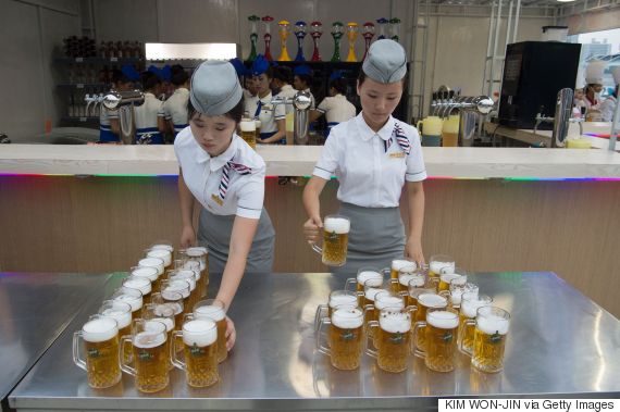 This photo taken on August 12, 2016 shows waitresses preparing jugs of beer before the opening of the Pyongyang Taedonggang Beer Festival on the banks of the Taedong river in Pyongyang. / AFP / Kim Won-Jin        (Photo credit should read KIM WON-JIN/AFP/Getty Images)
