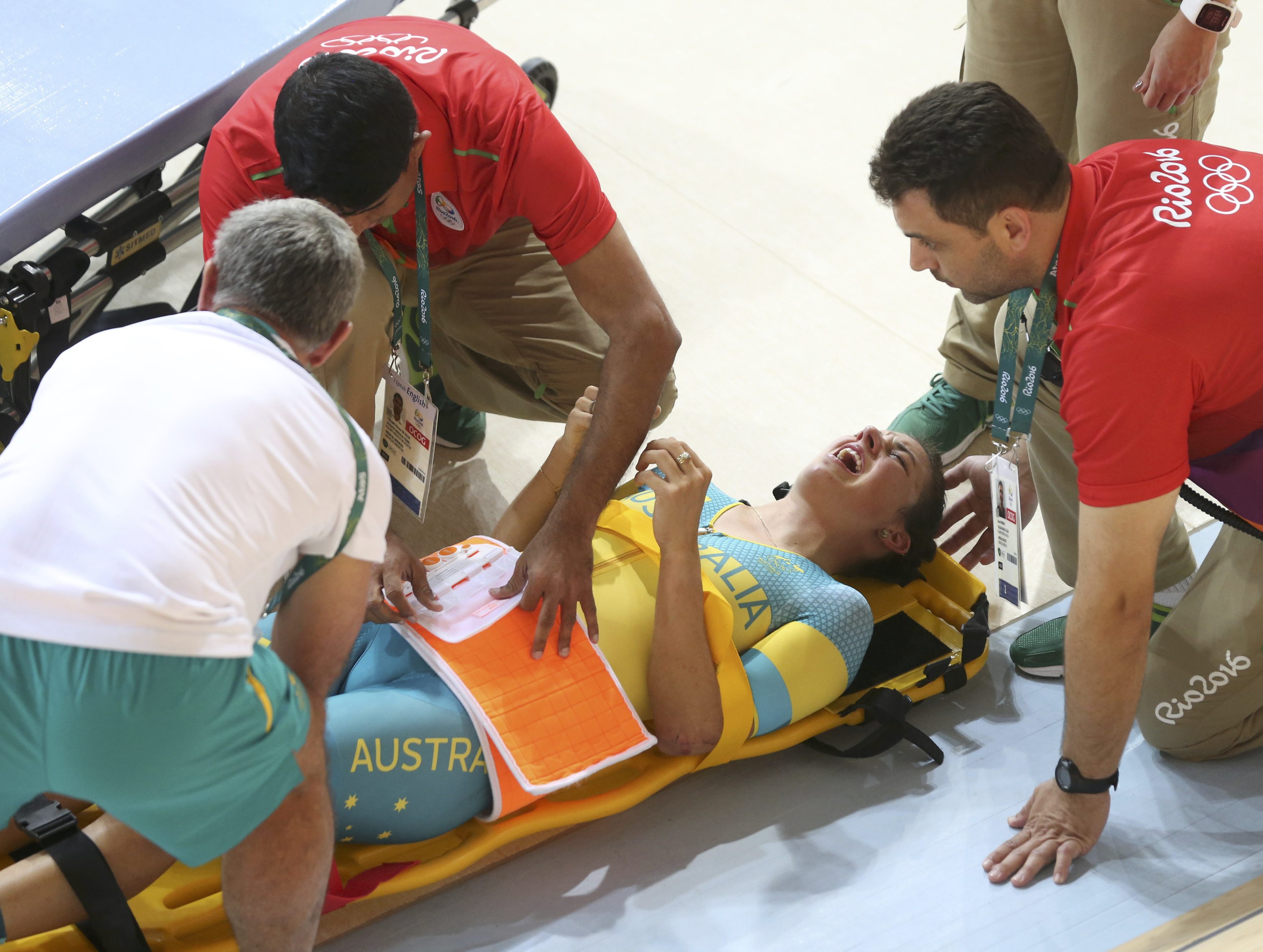 2016 Rio Olympics - Cycling Track - Preliminary - Team training - Rio Olympic Velodrome - Rio de Janeiro, Brazil - 08/08/2016. Australia's (AUS) women's team member Melissa Hoskins is aided after a crash during a practice session.  REUTERS/Eric Gaillard   FOR EDITORIAL USE ONLY. NOT FOR SALE FOR MARKETING OR ADVERTISING CAMPAIGNS.