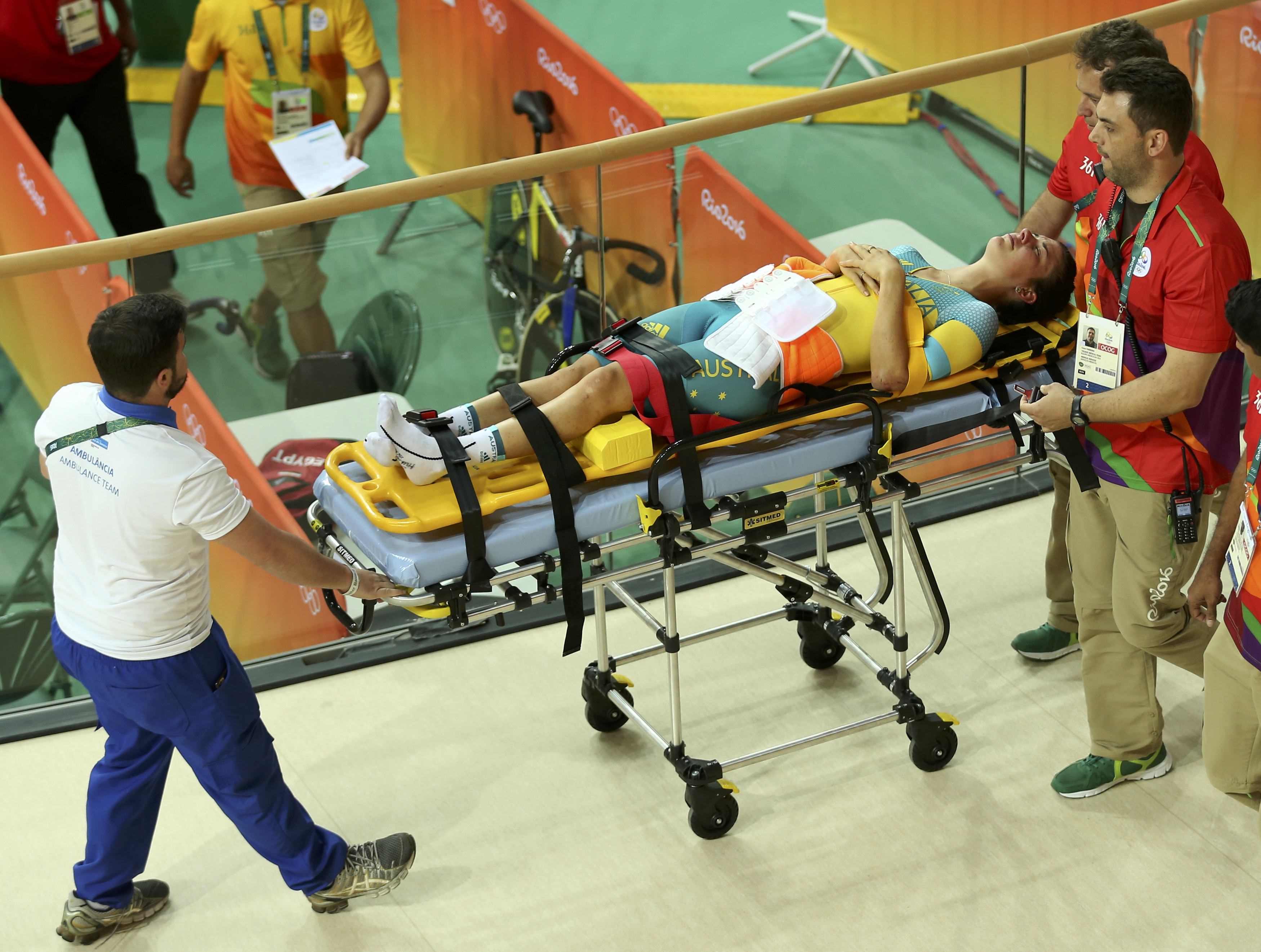 2016 Rio Olympics - Cycling Track - Preliminary - Team training - Rio Olympic Velodrome - Rio de Janeiro, Brazil - 08/08/2016. Australia's (AUS) women's team member Melissa Hoskins is aided after a crash during a practice session.  REUTERS/Matthew Childs   FOR EDITORIAL USE ONLY. NOT FOR SALE FOR MARKETING OR ADVERTISING CAMPAIGNS.