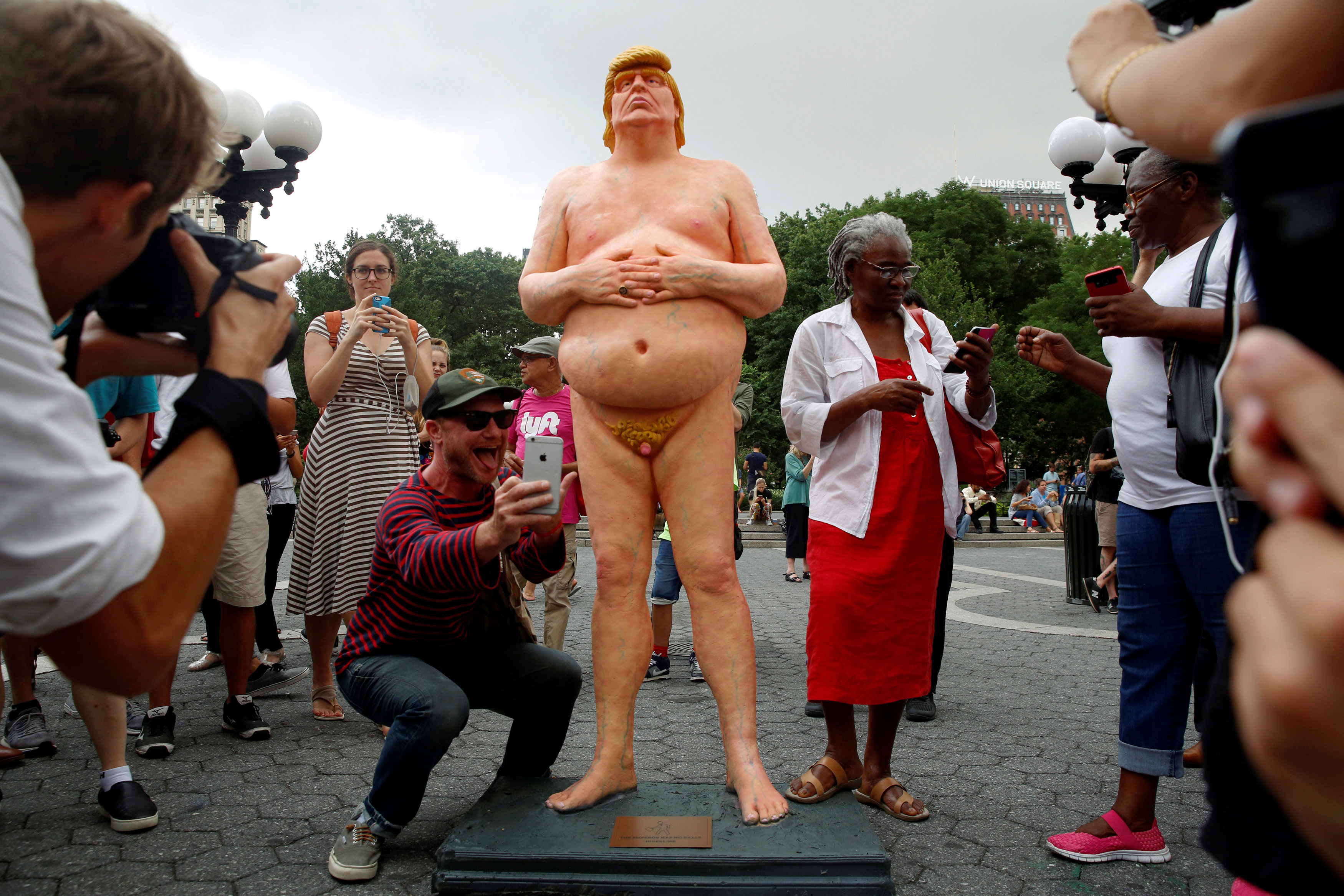REFILE - REMOVING RESTRICTIONS People photograph and pose for selfies with a naked statue of U.S. Republican presidential nominee Donald Trump that was left in Union Square Park in New York City, U.S. August 18, 2016.  REUTERS/Brendan McDermid  TEMPLATE OUT