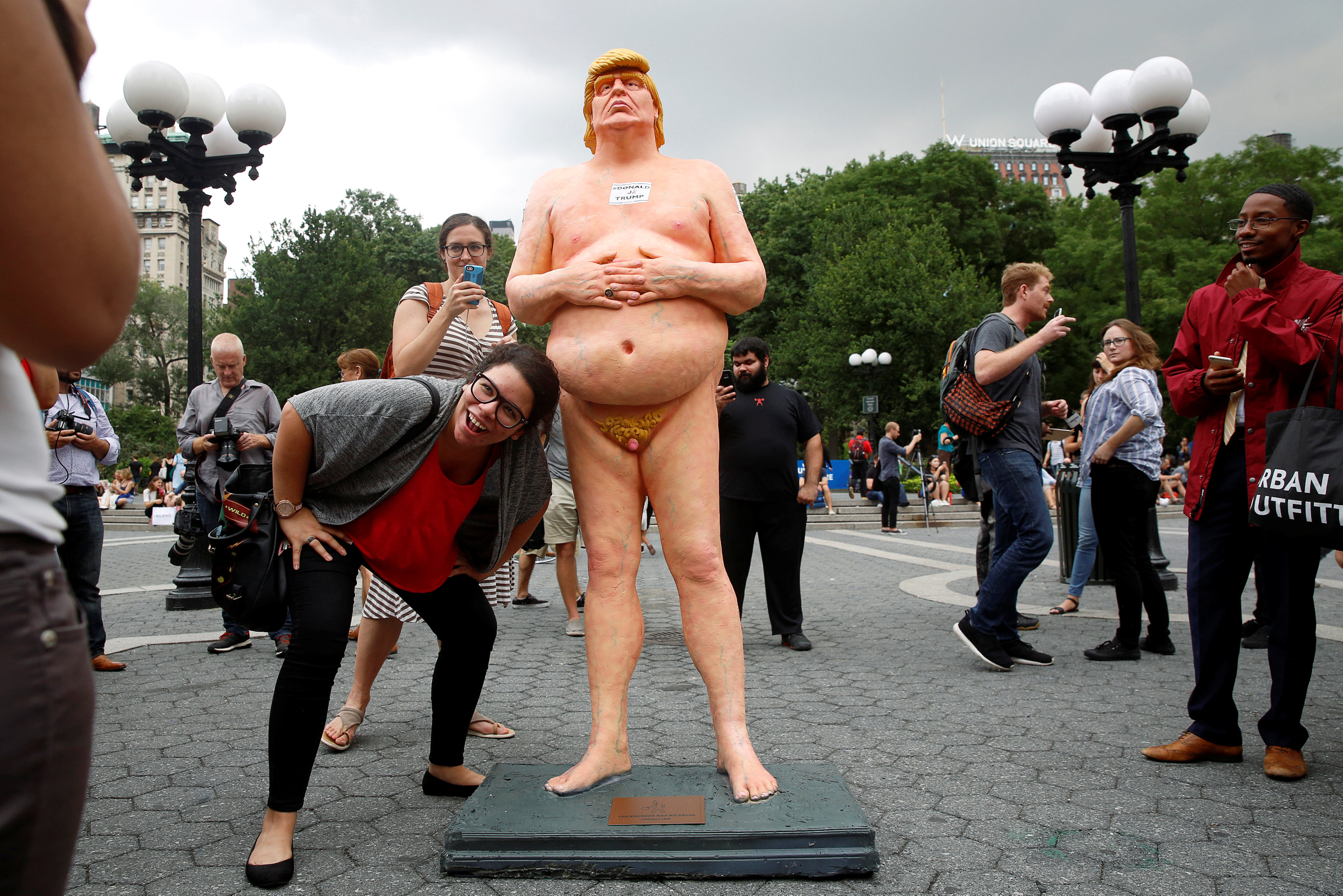REFILE - REMOVING RESTRICTIONS People photograph a naked statue of U.S. Republican presidential nominee Donald Trump that was left in Union Square Park in New York City, U.S. August 18, 2016.  REUTERS/Brendan McDermid   TEMPLATE OUT