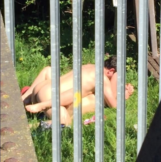 A couple in Doncaster, South Yorkshire, were caught on camera having SEX in broad daylight - just yards from hundreds of students in a college. See Ross Parry copy RPYSEX : A dark haired man and a blonde haired woman were filmed by a shocked onlooker who spotted the pair romping totally naked on a patch of grass. The couple stripped off behind a Cash and Carry depot and the onlooker captured the sorded act from behind a metal fence. The 90 second clip shows the man on top of the woman as they carry out the deed near to Doncaster College, South Yorks. During the clip, the woman, who is laid on her back, can be seen puffing on a cigarette during intercourse before discarding the fag end into the undergrowth.