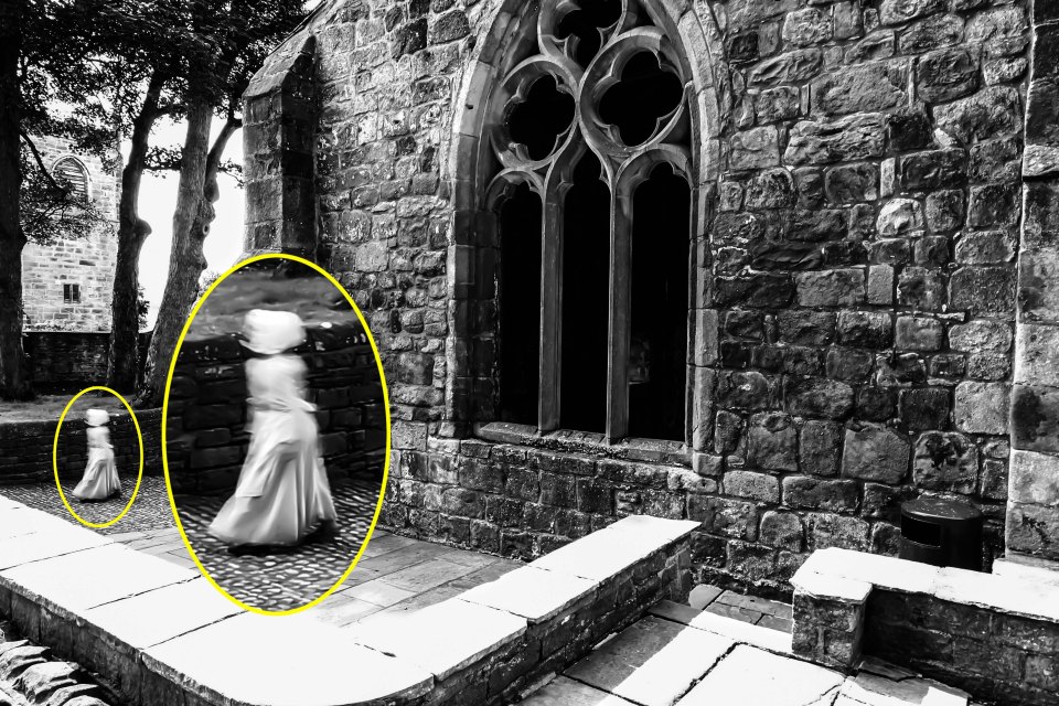 PIC FROM MERCURY PRESS (PICTURED: THE MAIN PICTURE SHOWING THE GHOST OF A LITTLE GIRL AT SKIPTON CASTLE, YORKSHIRE) A butcher has revealed a picture of what he claims is the ghost of a little girl wearing Georgian-period clothing and bonnet in the grounds of a 900-year-old castle. Mark Whitaker, 34, had visited Skipton Castle, Yorks, with his partner Amanda Ledgar, who was pregnant at the time, and had been snapping away like usual all day. It was only when he got back home in Colne, Lancs, that the then dad-to-be and now dad-of-one, noticed the three-foot tall ghostly figure walking by the castle. The image shows a clear figure in a white floor length period dress and a bonnet that appears to float where her head would be - though the eerie child has no visible arms or neck. Mark claims the image still sends a shiver down his spine whenever he looks at it but has now revealed it to see what others think. SEE MERCURY COPY
