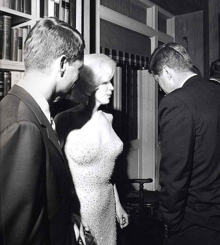 epa02191193 A black and white photo showing a rare image of Marilyn Monroe with President John F. Kennedy (R) and his brother Robert F. Kennedy together after JFK's 19 May 1962 birthday party. Monroe still wears the infamously tight-fighting, sheer rhinestone-studded dress she wore when singing earlier at Madison Square Garden in New York, NY, USA. No other known photo exists of the Kennedys with Monroe according to filmmaker Keya Morgan, who now owns the only original prints of it. Morgan said they were photographed together many times, but the Secret Service and the FBI confiscated every single photograph. Stoughton made and signed 10 prints for Morgan. Nine of them go on sale 8 June 2010 at the Art & Artifact Gallery in West Hollywood, California. EPA/CECIL STOUGHTON NO SALES, NO MAGS, NO ARCHIVES, ONE-TIME USE ONLY.