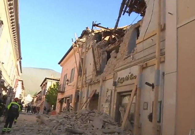 In this image made from video, firefighters stand in front of a damaged building in Norcia, Italy, Sunday, Oct. 30, 2016 after a powerful earthquake with a preliminary magnitude of 6.6 rocked central and southern Italy following a week of temblors left thousands homeless. (Sky Italia via AP)