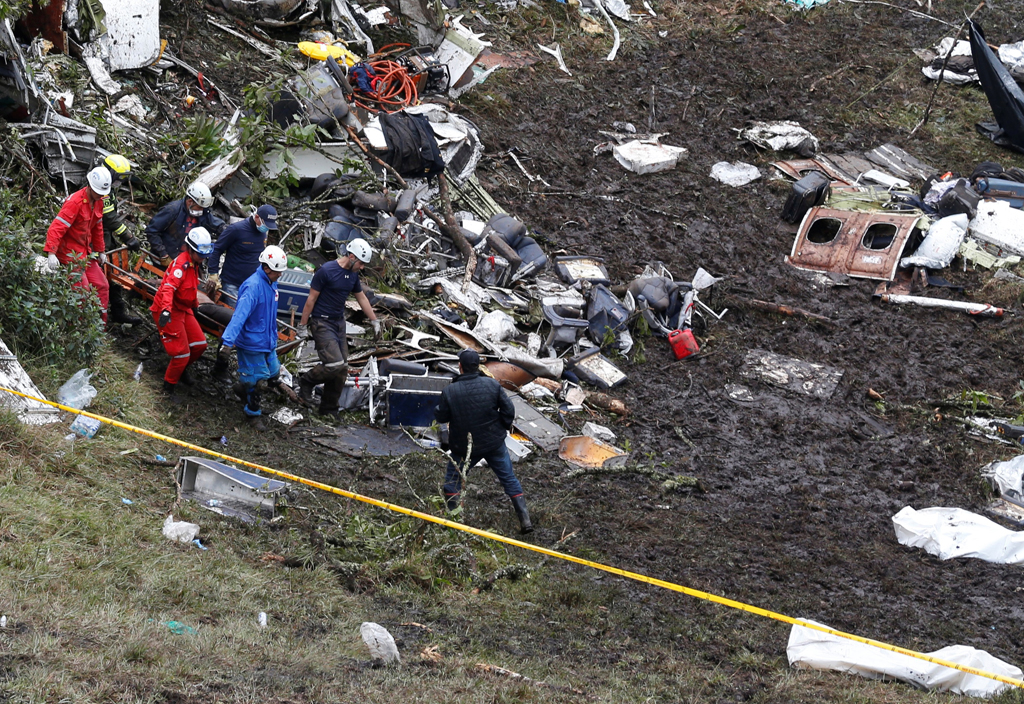 Rescue workers carry the body of a victim from a plane that crashed into the Colombian jungle with Brazilian soccer team Chapecoense onboard, near Medellin