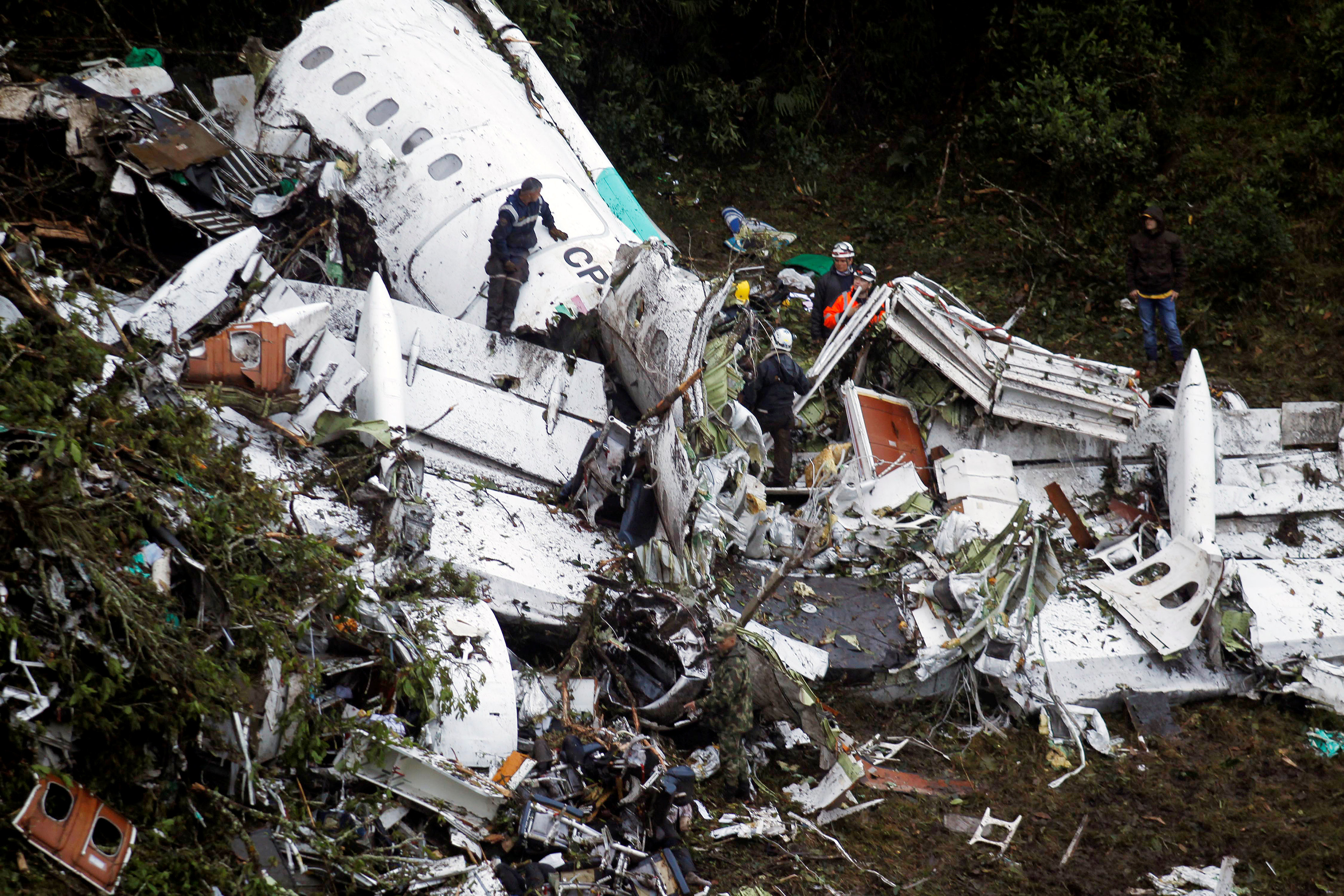 Rescue crew work in the wreckage from a plane that crashed into Colombian jungle with Brazilian soccer team Chapecoense near Medellin