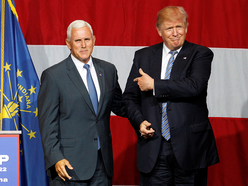 Republican presidential candidate Donald Trump, right, and Indiana Governor Mike Pence, left, wave to the crowd before addressing the crowd during a campaign stop at the Grand Park Events Center in Westfield, Indiana, on July 12, 2016. Photo courtesy of REUTERS/John Sommers II