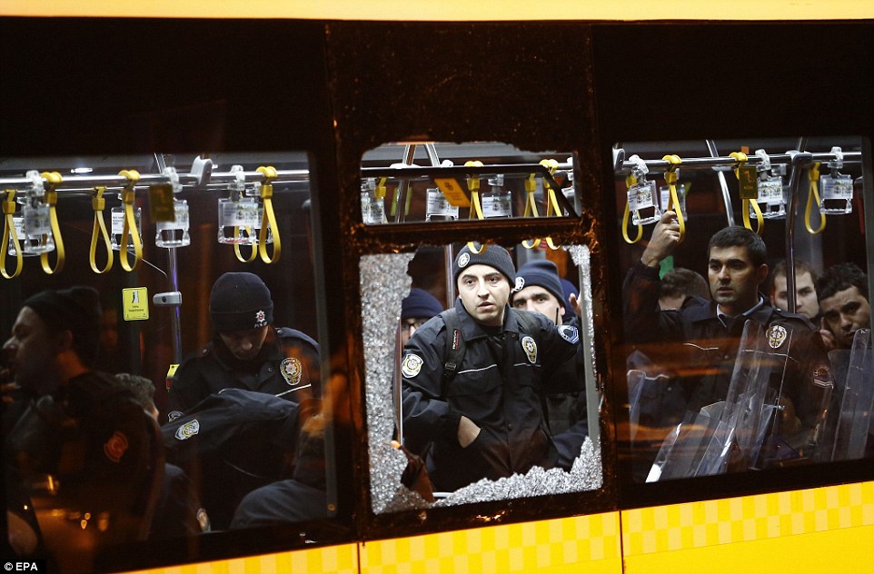 3B4055BB00000578-4020812-Police_officers_stand_inside_a_damaged_bus_after_the_explosion_t-a-9_1481413089887