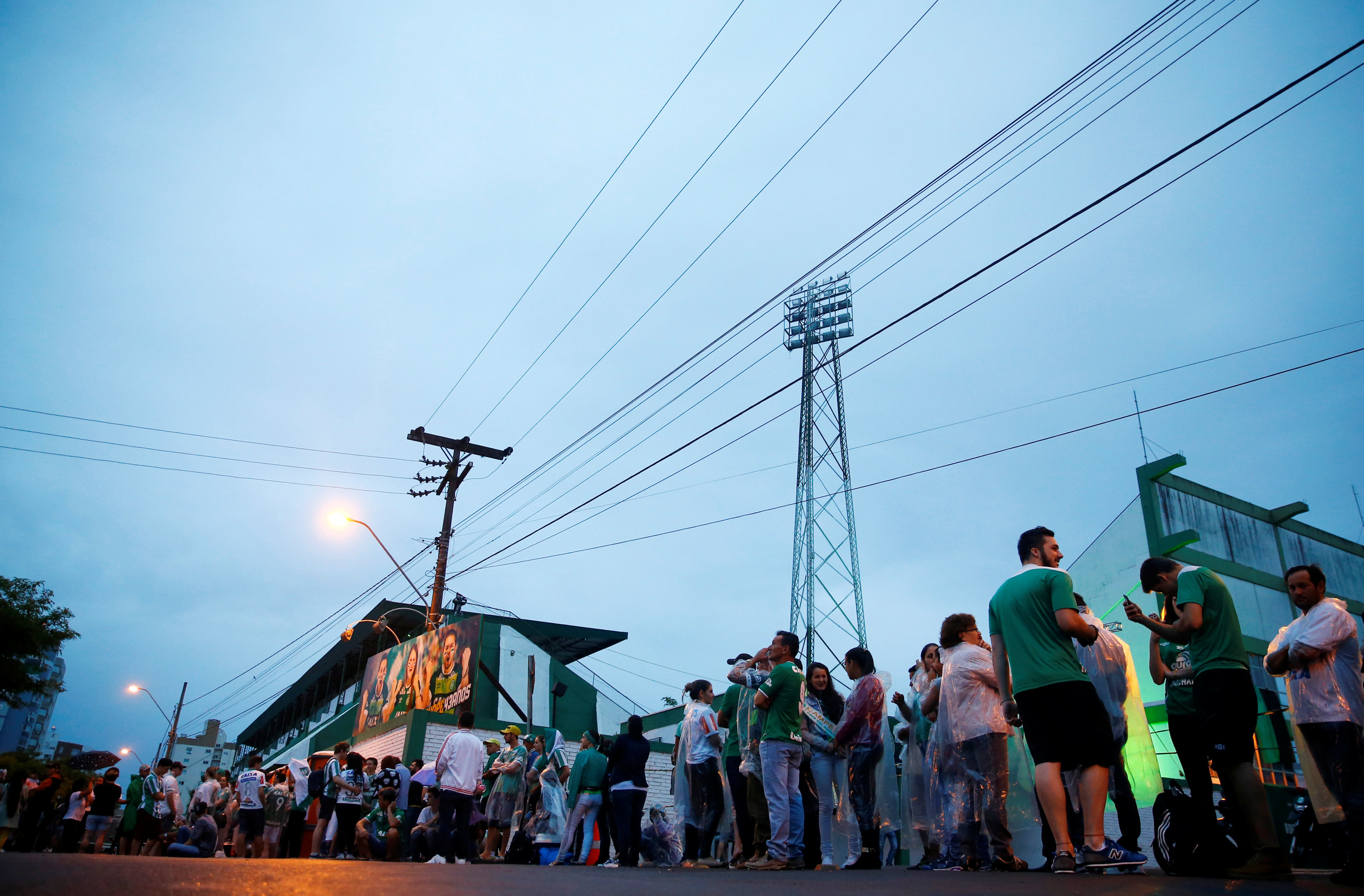 Fans of the Brazilian football team Chapecoense wait in front of the Arena Conda stadium to receive the bodies of the victims who died in the plane crash in Colombia, in Chapeco, Brazil