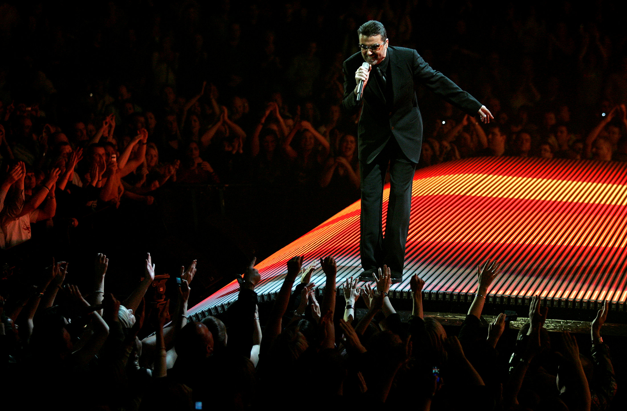 FILE PHOTO: British singer George Michael performs on the first night of the British leg of his tour at the MEN Arena in Manchester, northern England, November 17, 2006. REUTERS/Phil Noble/File Photo