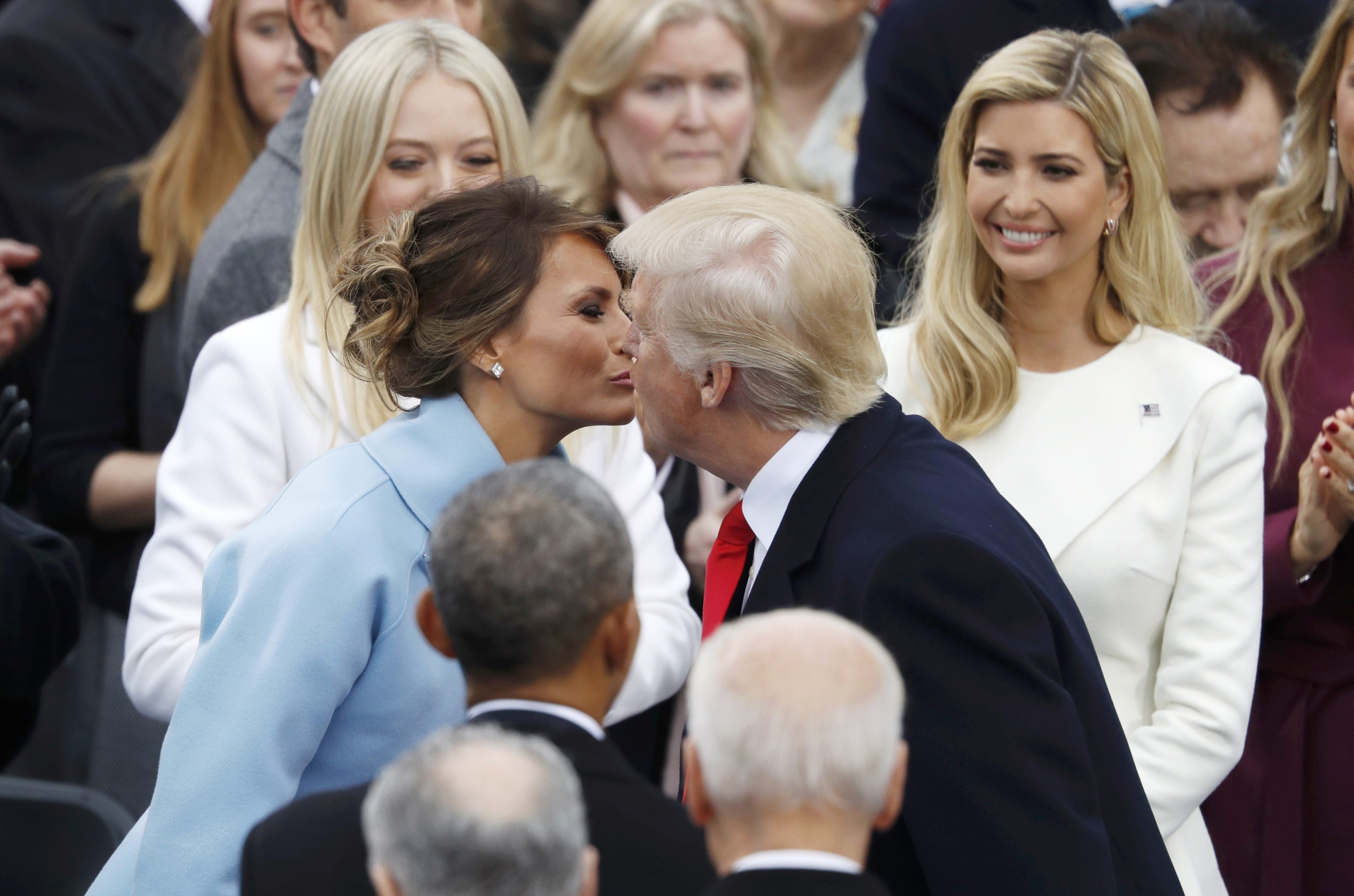 President-elect Donald Trump kisses his wife Melania as his daughters Tiffany (L) and Ivanka (R) look on during inauguration ceremonies swearing in Donald Trump as the 45th president of the United States on the West front of the U.S. Capitol in Washington, U.S., January 20, 2017. REUTERS/Lucy Nicholson