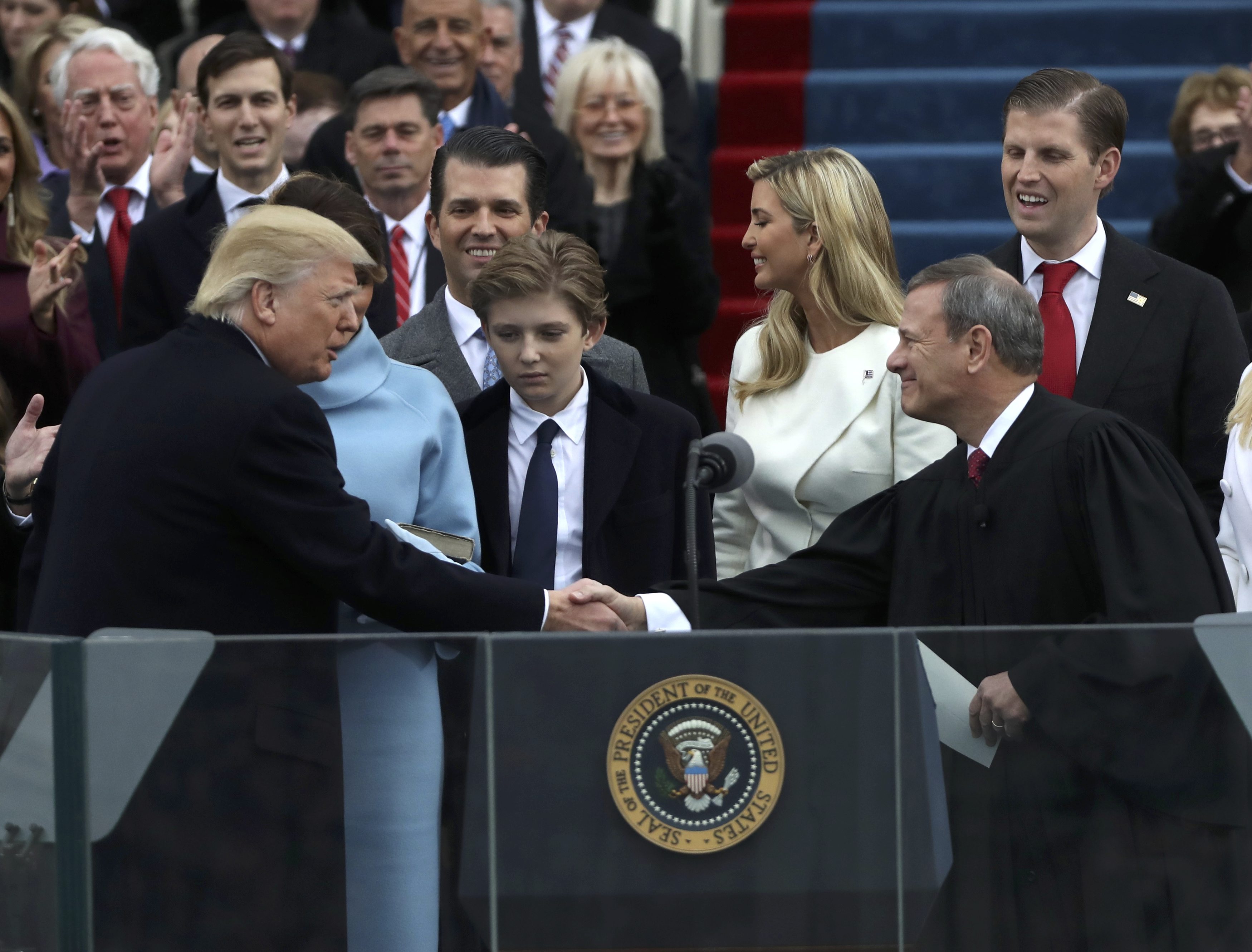 U.S. President Donald Trump shakes hands with U.S. Supreme Court Chief Justice John Roberts (R) after being sworn in as president with his wife Melania, and children Barron, Donald, Ivanka and Tiffany at his side during inauguration ceremonies at the Capitol in Washington, U.S.,  January 20, 2017. REUTERS/Carlos Barria
