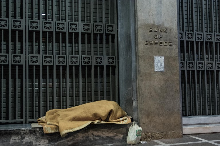 A homeless outside the Bank of Greece
