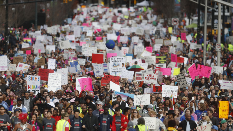 Demonstrators march Saturday, Jan. 21, 2017, in Atlanta. Thousands of people marched through Atlanta one day after President Donald Trump's inauguration. (AP Photo/John Bazemore)