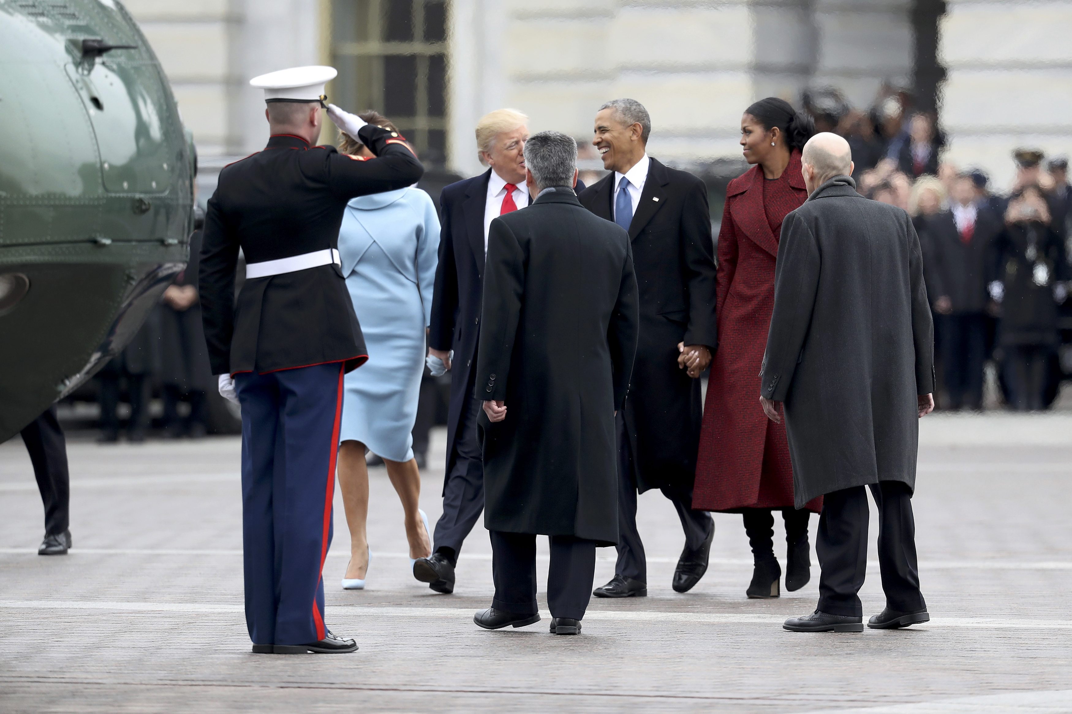 President Donald Trump and former president Barack Obama exchange words at the  U.S. Capitol as the Obamas prepare to depart in Washington, D.C., U.S., January 20, 2017. REUTERS/Rob Carr/Pool
