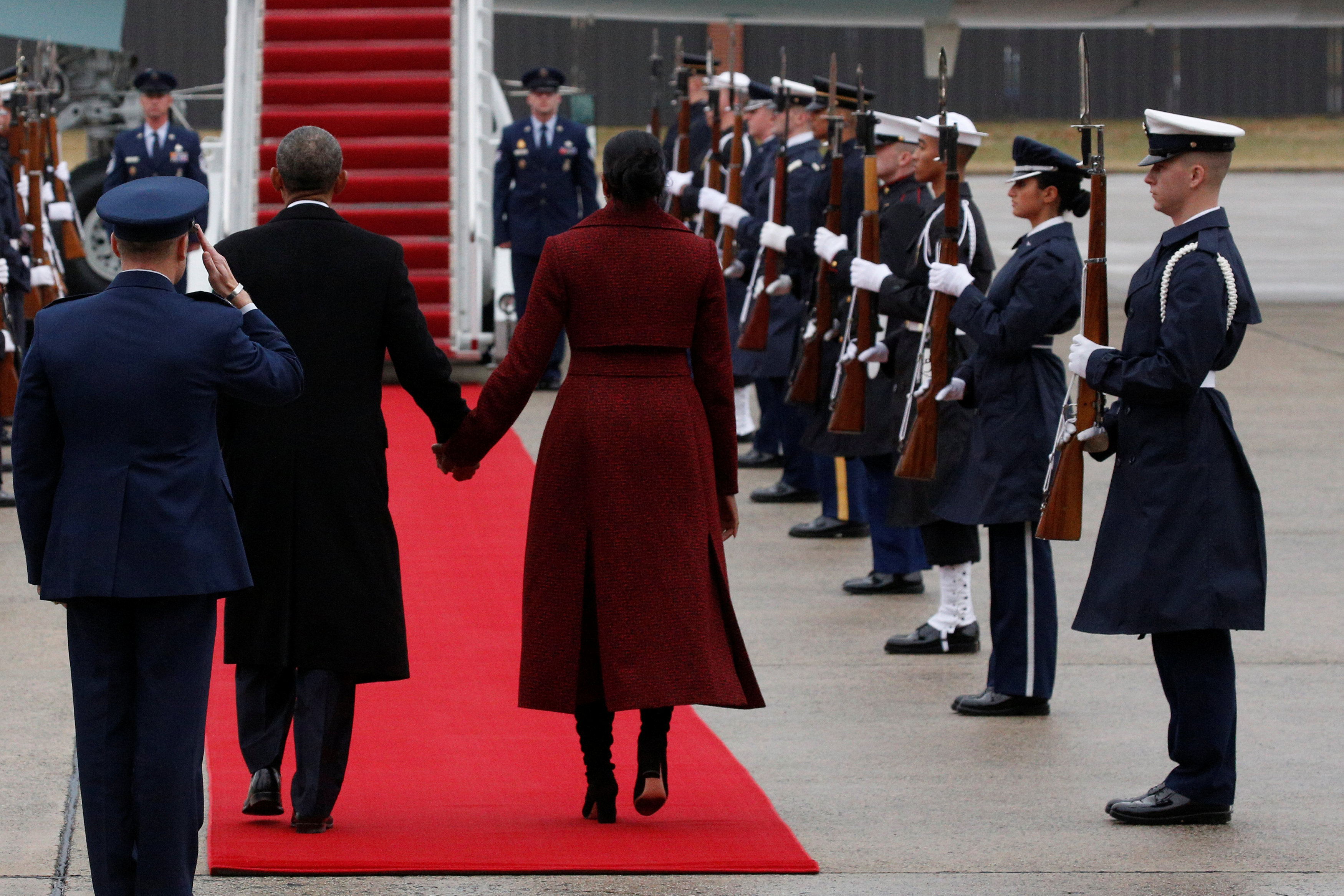 Former president Barack Obama and his wife, Michelle, walk to board Special Air Mission 28000, a Boeing 747 which serves as Air Force One, at Joint Base Andrews, Maryland, U.S., January 20, 2017. REUTERS/Brendan McDermid