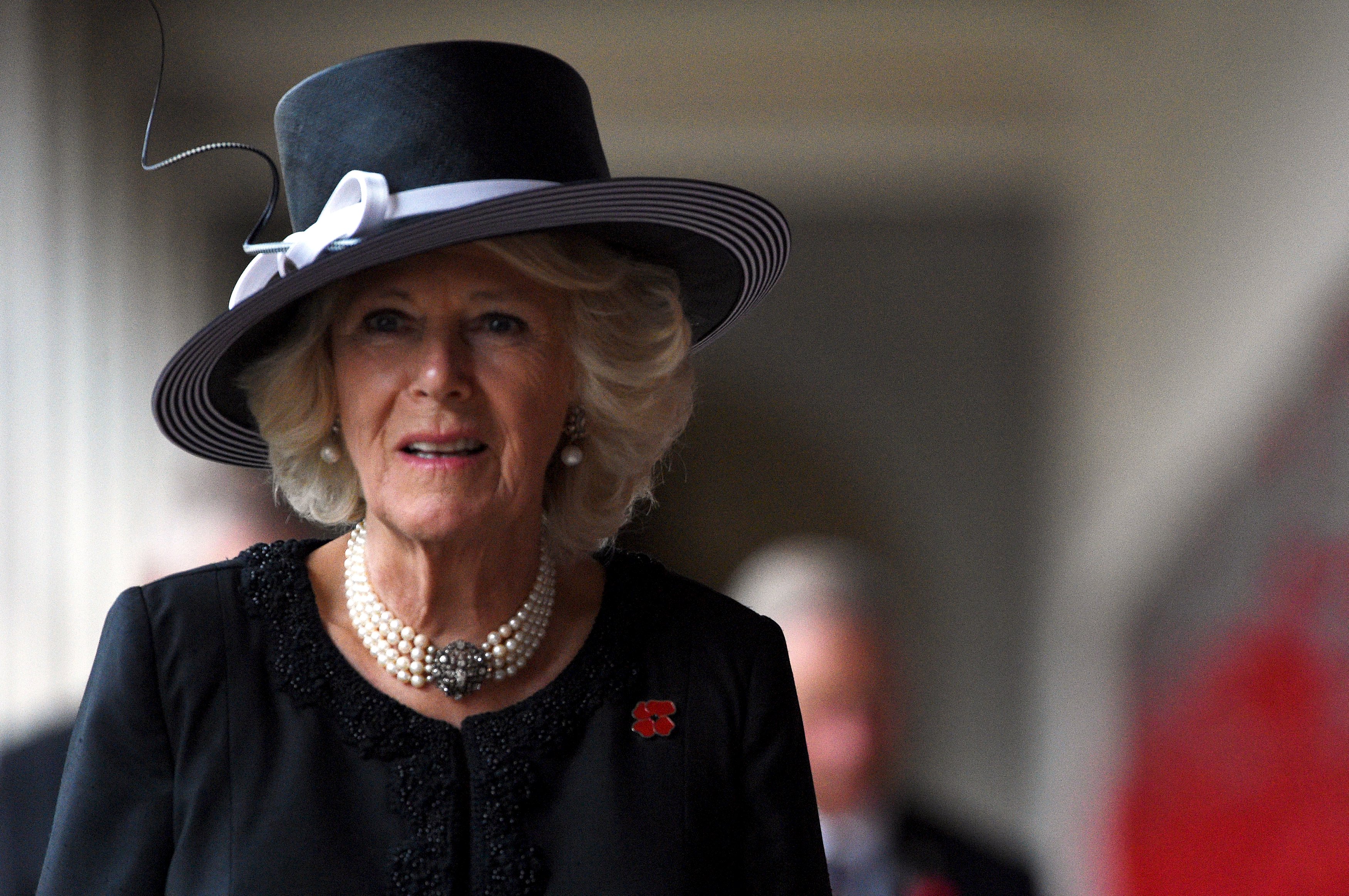 Camilla, Duchess of Cornwall, reacts as she walks along the Roll of Honour wall with her husband Britain's Prince Charles as they participate in a National Remembrance Day ceremony at the Australian War Memorial in Canberra, Australia, November 11, 2015. The royal couple are on a six-day official tour of Australia. REUTERS/Mick Tsikas/Pool