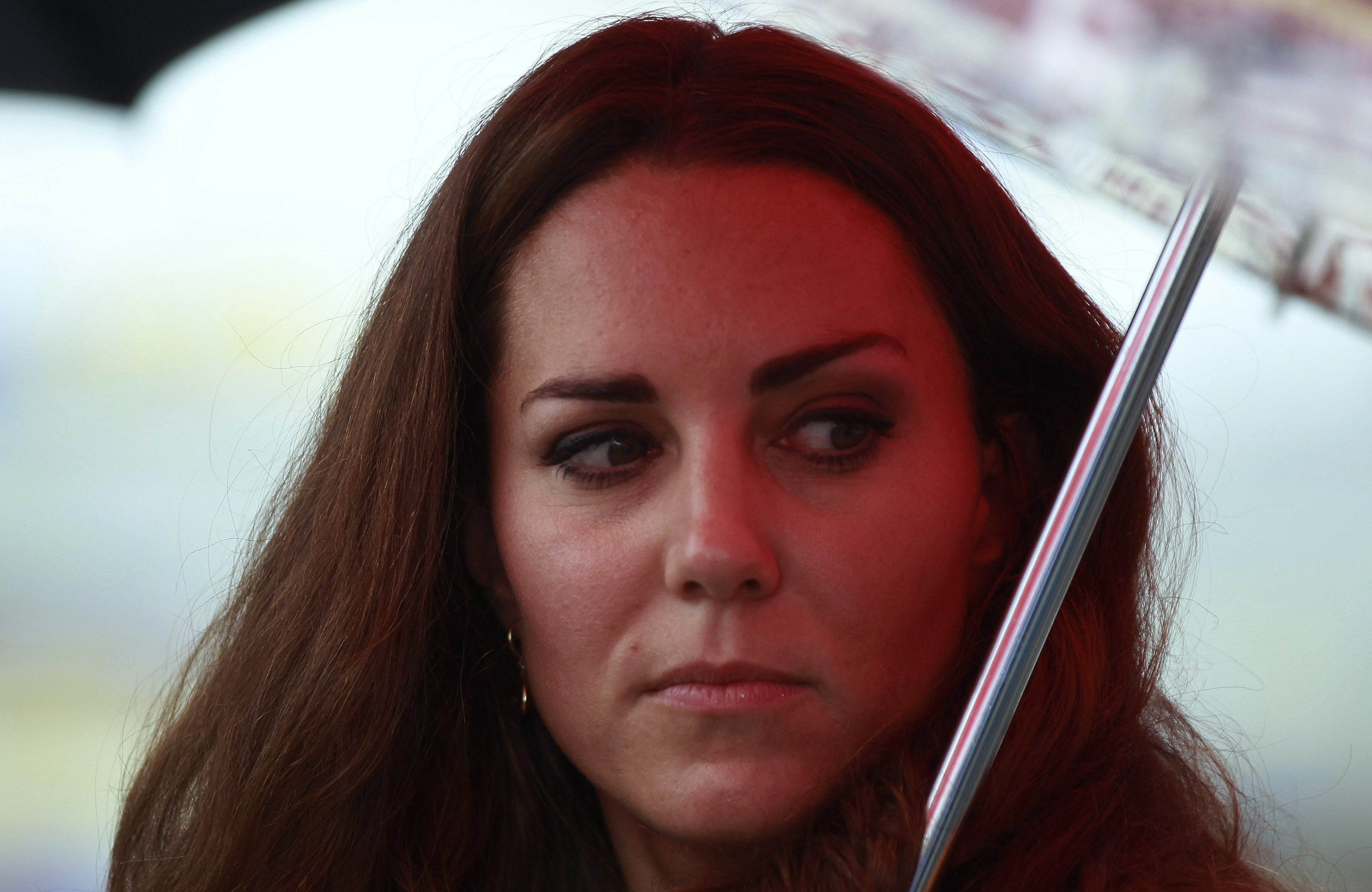 Britain's Catherine, the Duchess of Cambridge, looks back at the renovated Commonwealth Street in central Honiara September 17, 2012. Britain's Prince William and Catherine, the Duchess of Cambridge, are at the third stop of a nine-day tour of Southeast Asia and the South Pacific on behalf of Queen Elizabeth II to commemorate her Diamond Jubilee. REUTERS/Daniel Munoz (SOLOMON ISLANDS - Tags: ROYALS POLITICS ENTERTAINMENT)