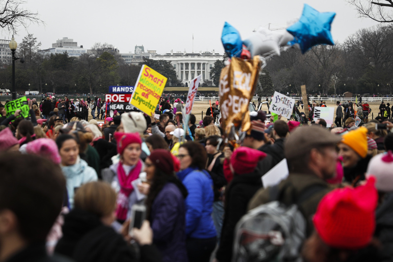 Protesters walk across Constitution Avenue near the White House for the Women's March on Washington during the first full day of Donald Trump's presidency, Saturday, Jan. 21, 2017 in Washington. Organizers of the Women's March on Washington expect more than 200,000 people to attend the gathering. Other protests are expected in other U.S. cities. (AP Photo/John Minchillo)