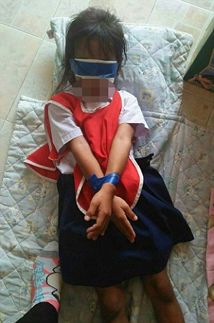 VIRAL PRESS - NEWS COPY - WITH PICTURES - 07771706292 These shocking pictures show how two five-year-old girls were bound and blindfolded with Scotch tape because they were not concentrating in class. The two pupils - who have not been identified - received the cruel punishment in front of classmates after ripping paper - sparking a furious reaction from the two female teachers last week. Pictures of the pair taken by a third teacher were handed to parents of the girls earlier this week and the school defended the teachers - with the headmaster saying it was a good way to teach them how to concentrate. But after the images sparked outrage online and a father of one of the girls contacted police, the two teachers have since been ordered to pay 40,000THB (915GBP) in compensation and authorities have launched an urgent investigation into the school in Surin, Thailand. The furious father said: ëíThe teacher who gave me the pictures told me that the other teachers had punished my daughter and friend by strapping their hands together then he blindfolded them. ëíWe think that another girl was hit but we donít have a picture of this. The children were just playing with the paper and they ripped it. The teachers said they had done something wrong and punished them like this. ëíThey said ëclose your eyesí and then they put white paper and blue Scotch tape to cover their eyes. Then another layer and bound their hands together. ëíThe teacher who found them said the girls were crying, trembling and sobbing terribly. I fear that I will have to send to the police. ëíThe teachers threatened them and both were frightened and did not know what else to do.'' A crisis meeting was held was held yesterday (Thu) which was attended by the headmaster, the parents, the two female teachers responsible and local police. Each teacher agreed to pay 20,000THB (457GBP) in compensation and requested transfers to different schools. Narong Meuanchart, the deputy education department chief in the province, said a committee had been set up to investigate the abuse and the pair could face further legal action. ENDS (FEE: 40 for 1st pictyure, 20 for 2nd)