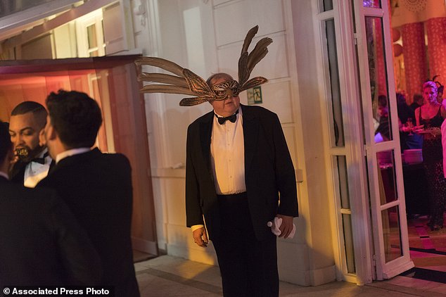A guest wearing a mask attends a traditional Carnival ball at the Copacabana Palace hotel in Rio de Janeiro, Brazil, Saturday, Feb. 25, 2017. In stark contrast to the hundreds of hard-charging street parties across Rio that are open to anyone, the "Baile do Copa" bills itself as a fairytale event where the country's elite can see and be seen in a hotel known for both opulence and a lengthy tradition of welcoming world leaders and stars. (AP Photo/Leo Correa)