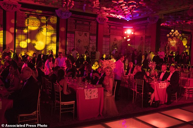 Guests enjoy a traditional Carnival ball at the Copacabana Palace hotel in Rio de Janeiro, Brazil, Saturday, Feb. 25, 2017. In stark contrast to the hundreds of hard-charging street parties across Rio that are open to anyone, the "Baile do Copa" bills itself as a fairytale event where the country's elite can see and be seen in a hotel known for both opulence and a lengthy tradition of welcoming world leaders and stars. (AP Photo/Leo Correa)