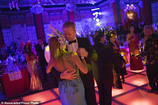 A couple dances during a traditional Carnival ball at the Copacabana Palace hotel in Rio de Janeiro, Brazil, Saturday, Feb. 25, 2017. In stark contrast to the hundreds of hard-charging street parties across Rio that are open to anyone, the "Baile do Copa" bills itself as a fairytale event where the country's elite can see and be seen in a hotel known for both opulence and a lengthy tradition of welcoming world leaders and stars. (AP Photo/Leo Correa)