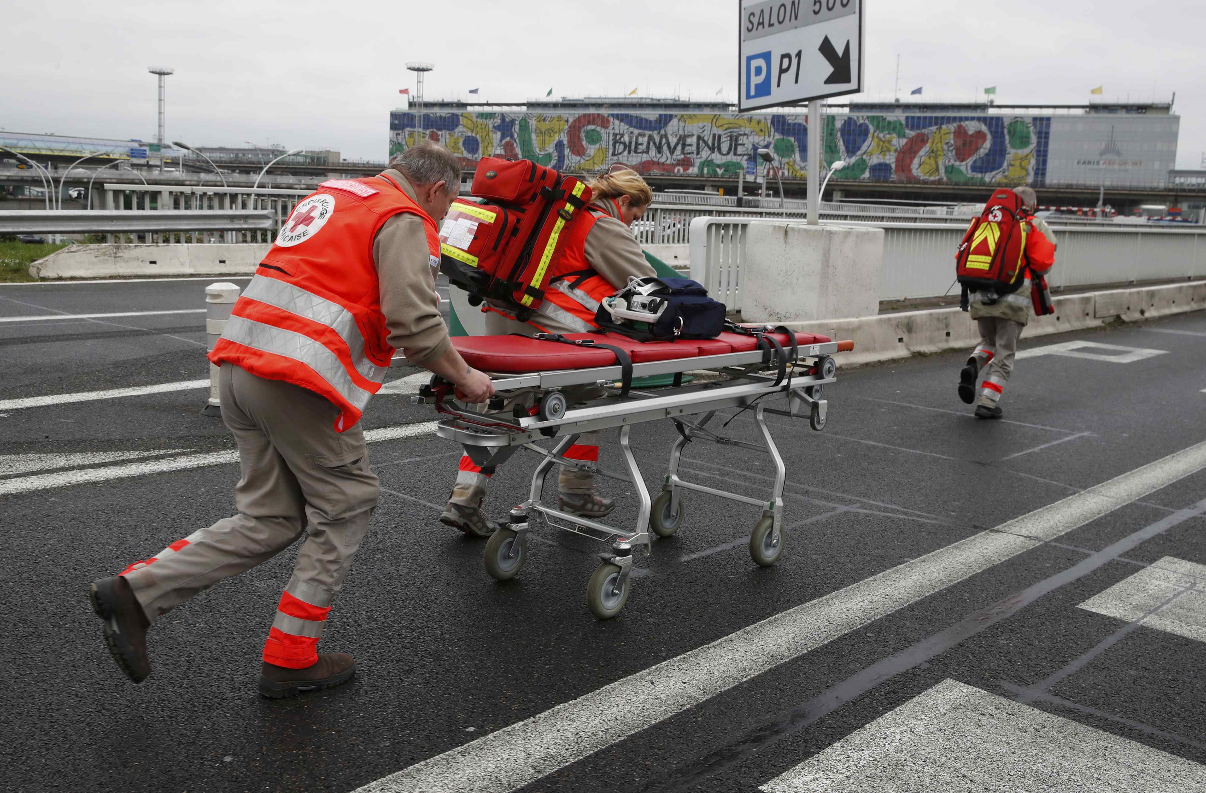 A medical gurney is wheeled into Orly airport southern terminal after shooting incident near Paris
