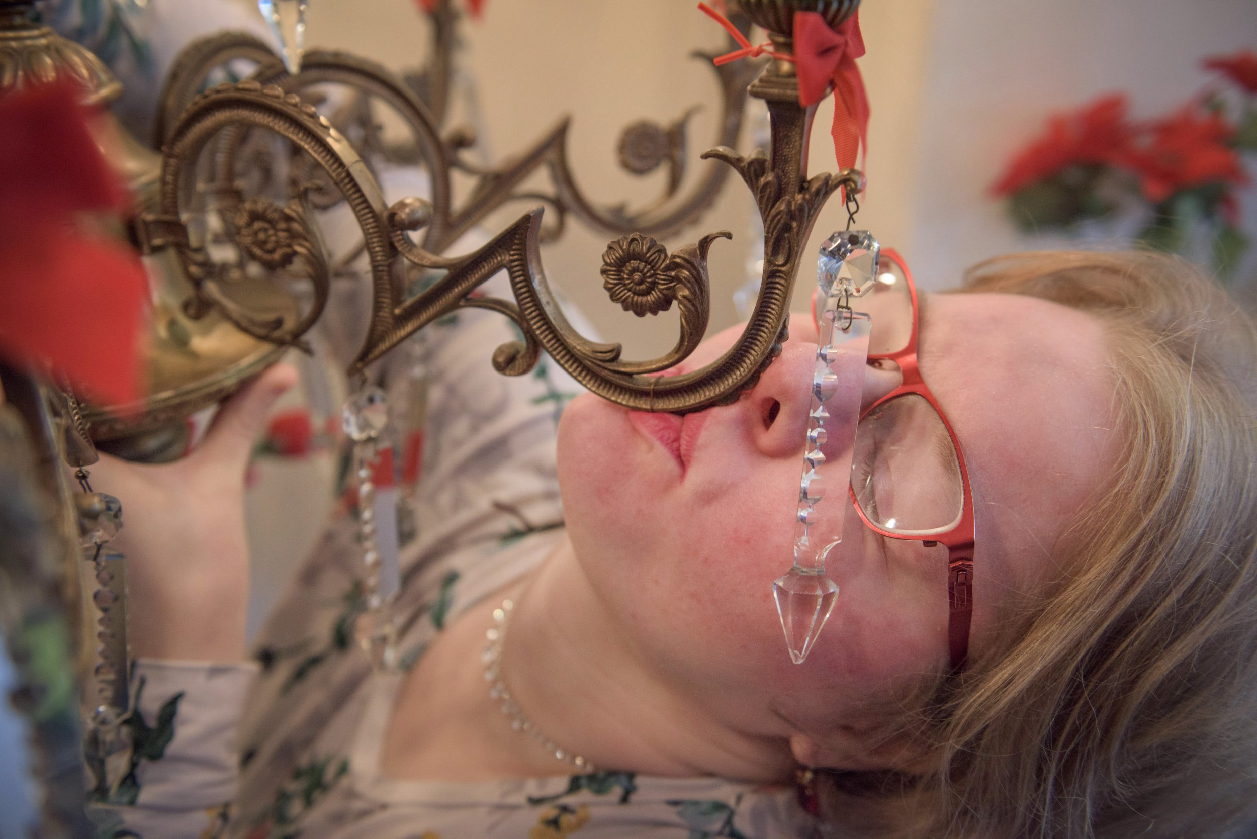 **MANDATORY BYLINE** Pic by Michael Scott/Caters News - (PICTURED: Amanda Liberty, 33, from Leeds kisses her favourite chandelier, Lumiere. Pic taken 01/12/2017.) - A woman has fallen in love with a 90-year-old chandelier she bought online - and the inseparable pair are now engaged. Amanda Liberty, 33, has been in a relationship with the 70cm wide chandelier, named Lumiere, for just over 12 months after spotting it on eBay. She claims it was love at first sight and after spending 400 pounds on the antique from Germany, Lumiere hasnt left her side since. SEE CATERS COPY