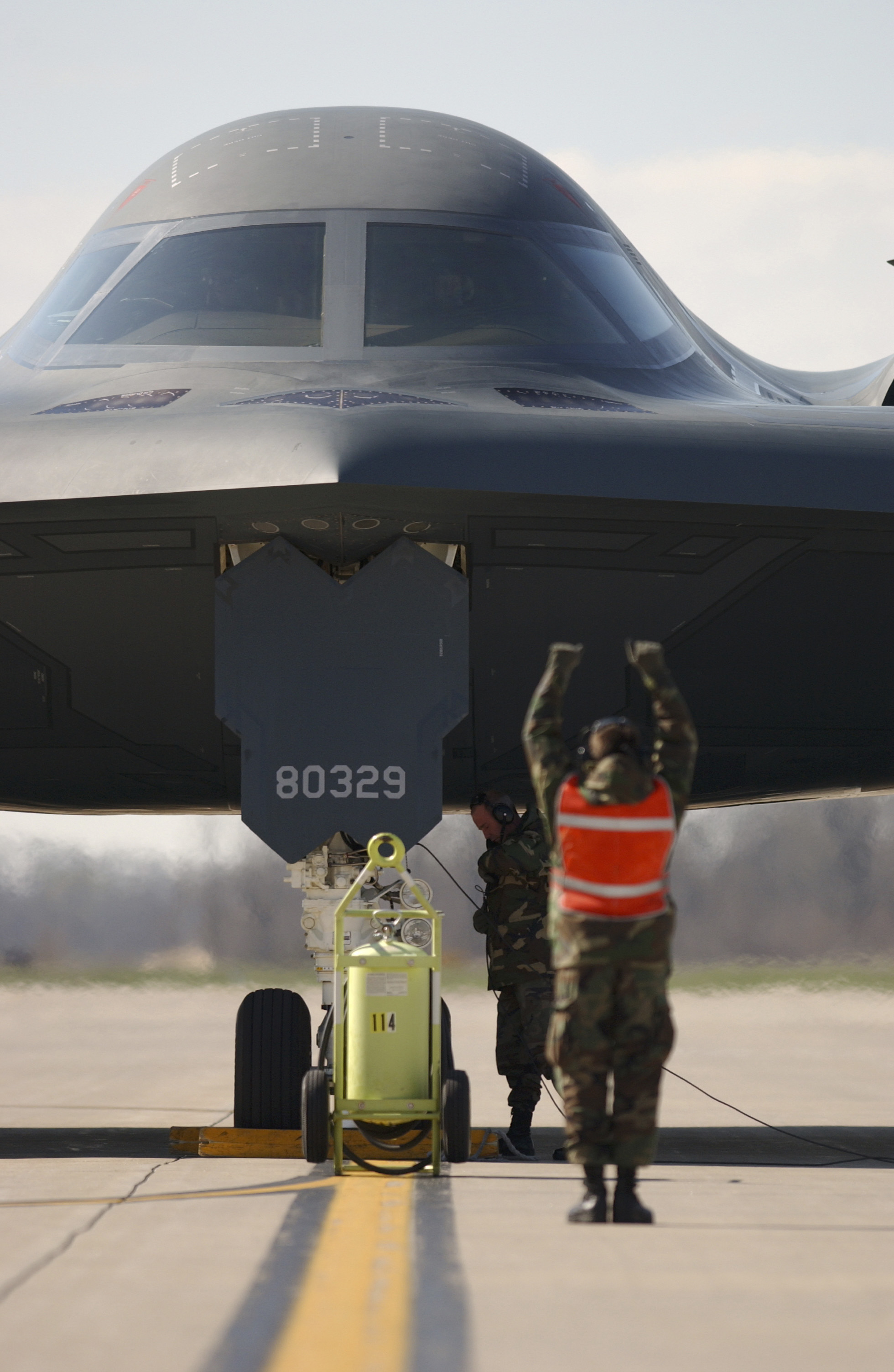 OPERATION IRAQI FREEDOM -- Airman 1st Class David Moses, a crew chief from the 509th Aircraft Maintenance Squadron at Whiteman Air Force Base, Mo., marshalls the B-2 named "Spirit of Missouri" on March 31 at a forward-deployed location. The B-2 was returning from a combat mission over Iraq in support of Operation Iraqi Freedom. (U.S. Air Force photo by Tech. Sgt. Michael R. Nixon)