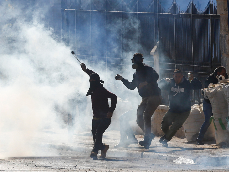 Palestinians clash with Israeli troops during a protest against U.S. President Donald Trump's decision to recognize Jerusalem as the capital of Israel in the West Bank city of Bethlehem, Friday, Dec.8, 2017.(AP Photo/Nasser Shiyoukhi)