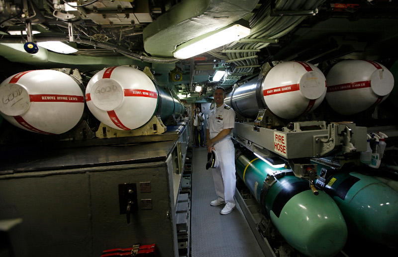 Alan Nelson, executive officer of USS Hampton from California stands next to some Tomahawk missiles at the Los Angeles-class, fast attack submerine USS Hampton in Hong Kong water, Tuesday, May. 17, 2011. The submarine arrived in Hong Kong May 15 for a port visit as part of it's deployment to the Western Pacific. This is the first port visit in three years conducted by a U.S. submarine in Hong Kong. (AP Photo/Vincent Yu)