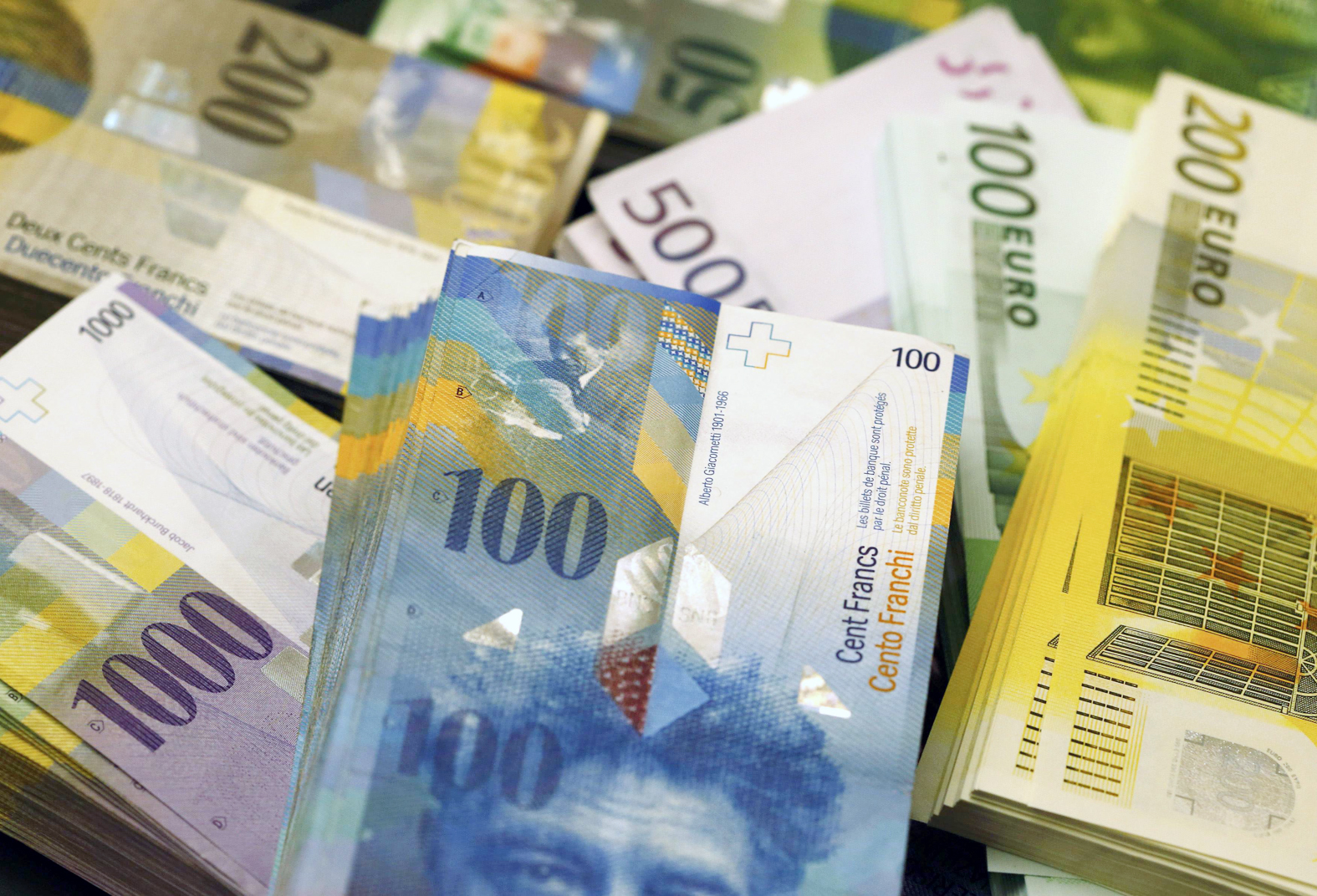File photo shows Swiss Franc and Euro banknotes of several values in Swiss bank in Bern