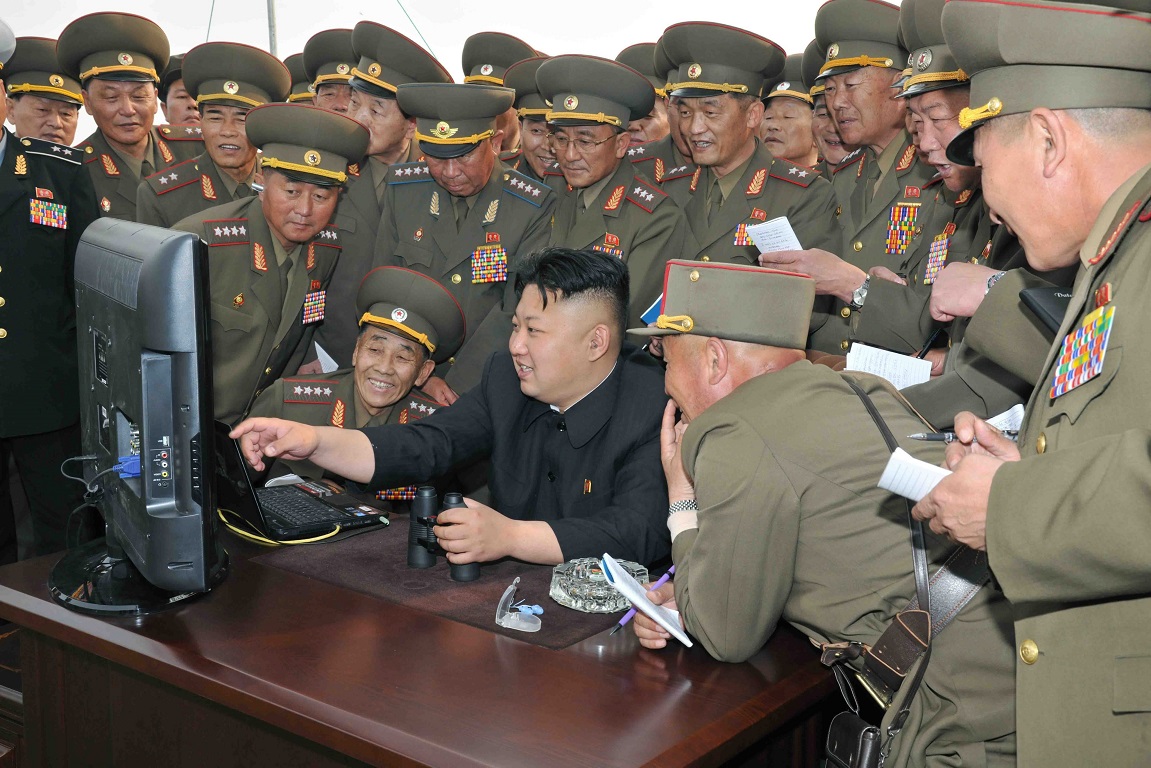 epa04183185 An undated picture released by the North Korean Central News Agency (KCNA) on 27 April 2014 shows North Korean leader Kim Jong-un (C) looking at a computer along with soldiers of a long-range artillery unit during its firing drill at an undisclosed location in North Korea.  EPA/KCNA SOUTH KOREA OUT  NO SALES